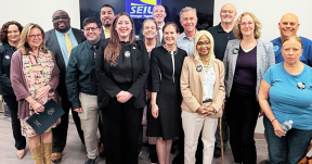 Union leaders gathered with state lawmakers and the governor to celebrate signing workplace violence protections into law